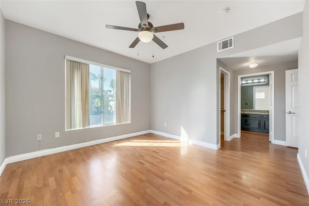7173 S Durango Drive, #212, Las Vegas, NV 89113 Gleaming hardwood floors and a wide window define this comfortable bedroom suite.