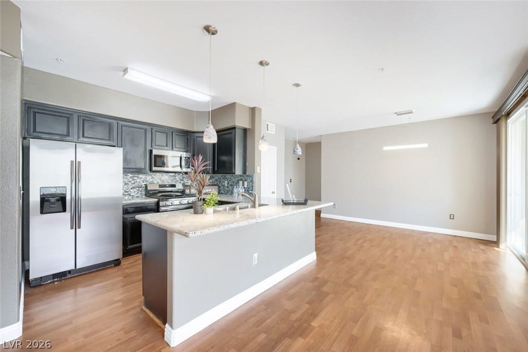 7173 S Durango Drive, #212, Las Vegas, NV 89113 Gleaming wood floors anchor this open-concept layout connecting the kitchen to the dining area.