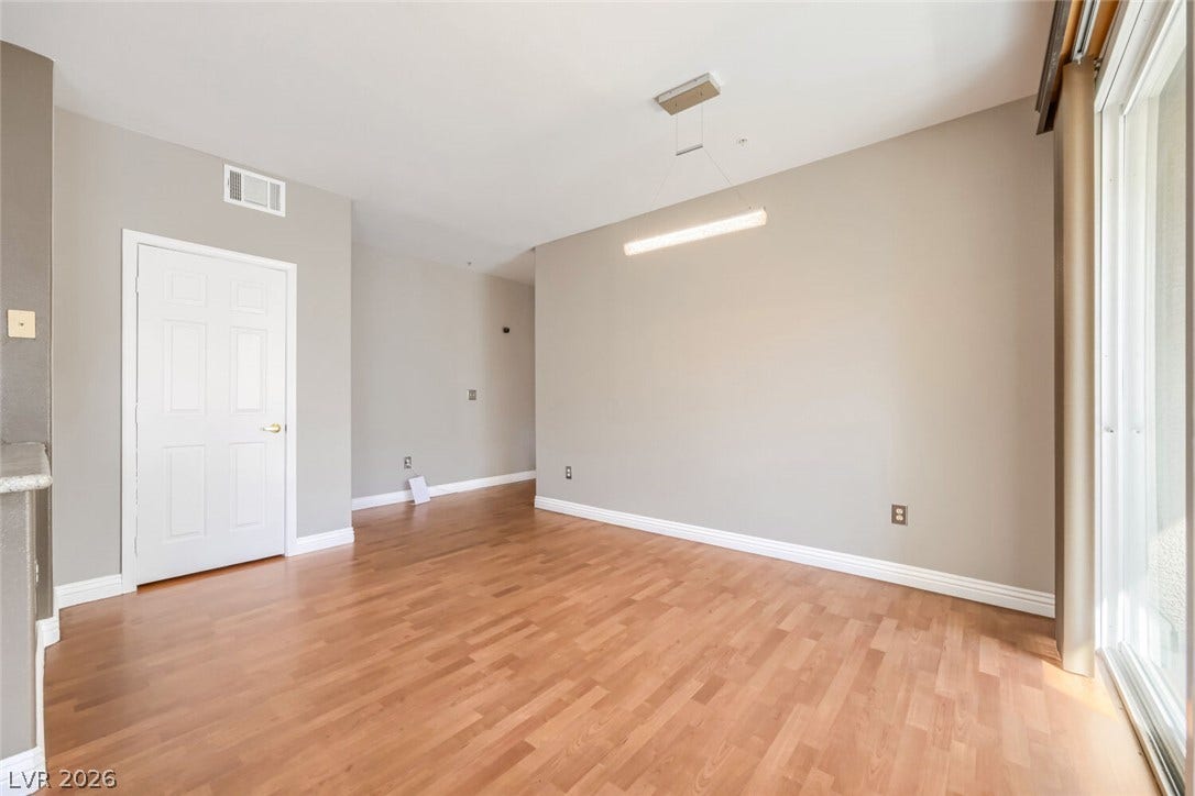 7173 S Durango Drive, #212, Las Vegas, NV 89113 Gleaming hardwood floors and a modern linear fixture anchor this versatile dining area.