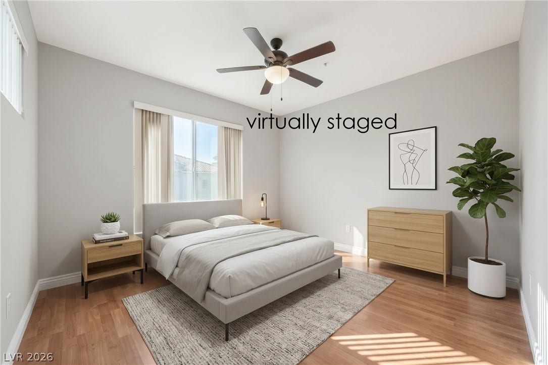 7173 S Durango Drive, #212, Las Vegas, NV 89113 Rich wood-look flooring and tall windows create a warm, inviting atmosphere in this bedroom.
