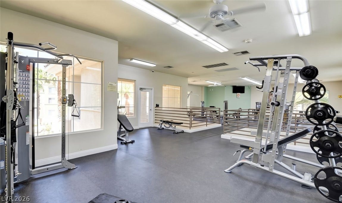 7173 S Durango Drive, #212, Las Vegas, NV 89113 A well-equipped fitness center offers smooth rubber flooring and expansive windows overlooking the grounds.