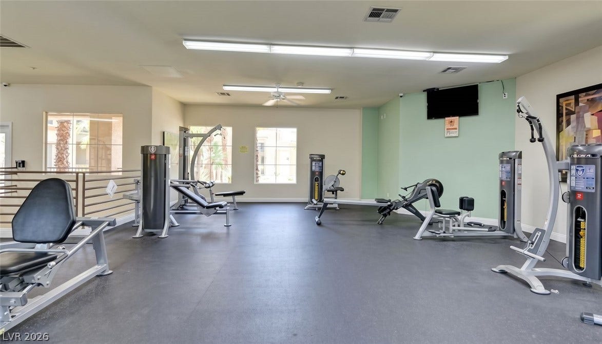 7173 S Durango Drive, #212, Las Vegas, NV 89113 High ceilings and durable rubber flooring create a functional workout space with outdoor views.