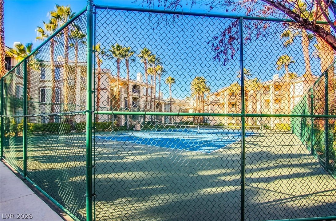7173 S Durango Drive, #212, Las Vegas, NV 89113 An outdoor sports court sits surrounded by protective fencing and manicured grounds.