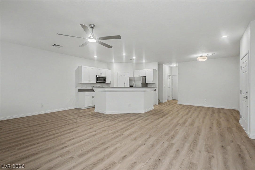 1555 Ward Frontier Lane, Henderson, NV 89002 Gleaming wood-look floors anchor a sweeping, open-concept living area and kitchen.