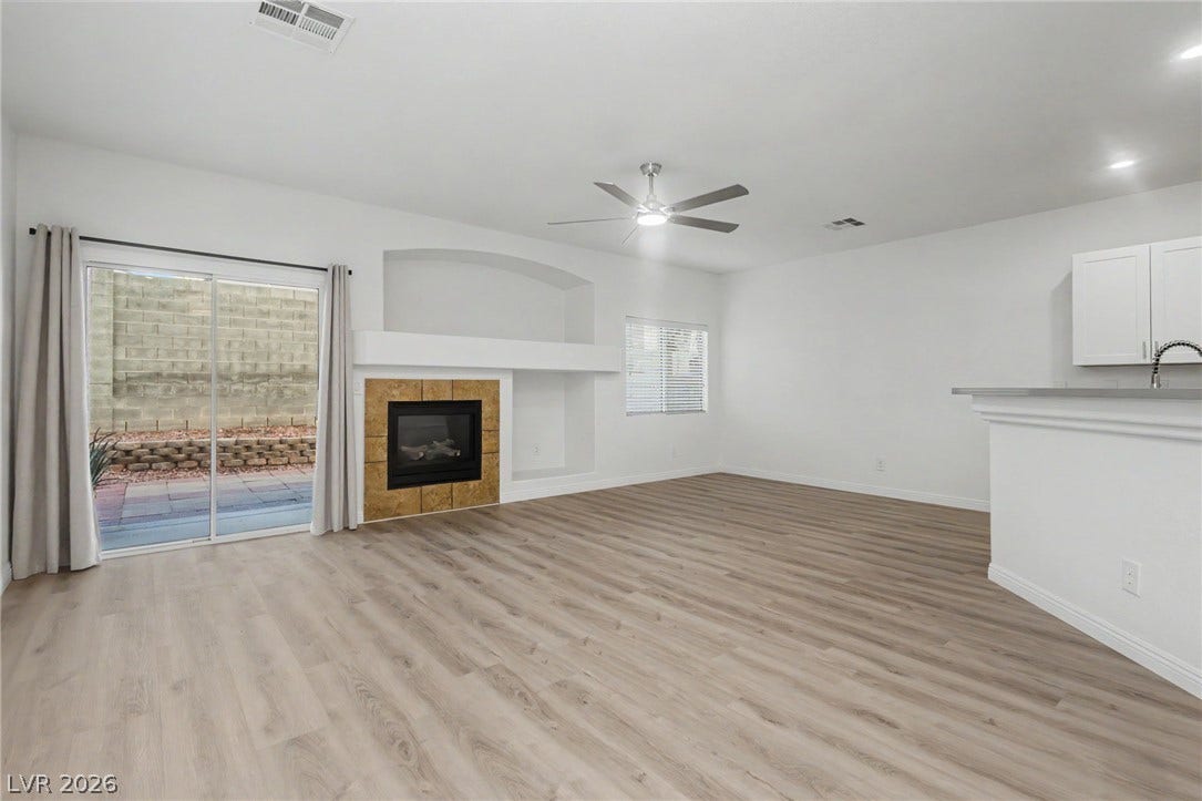 1555 Ward Frontier Lane, Henderson, NV 89002 An open floor plan connects the living space to the kitchen alongside sliding glass doors.
