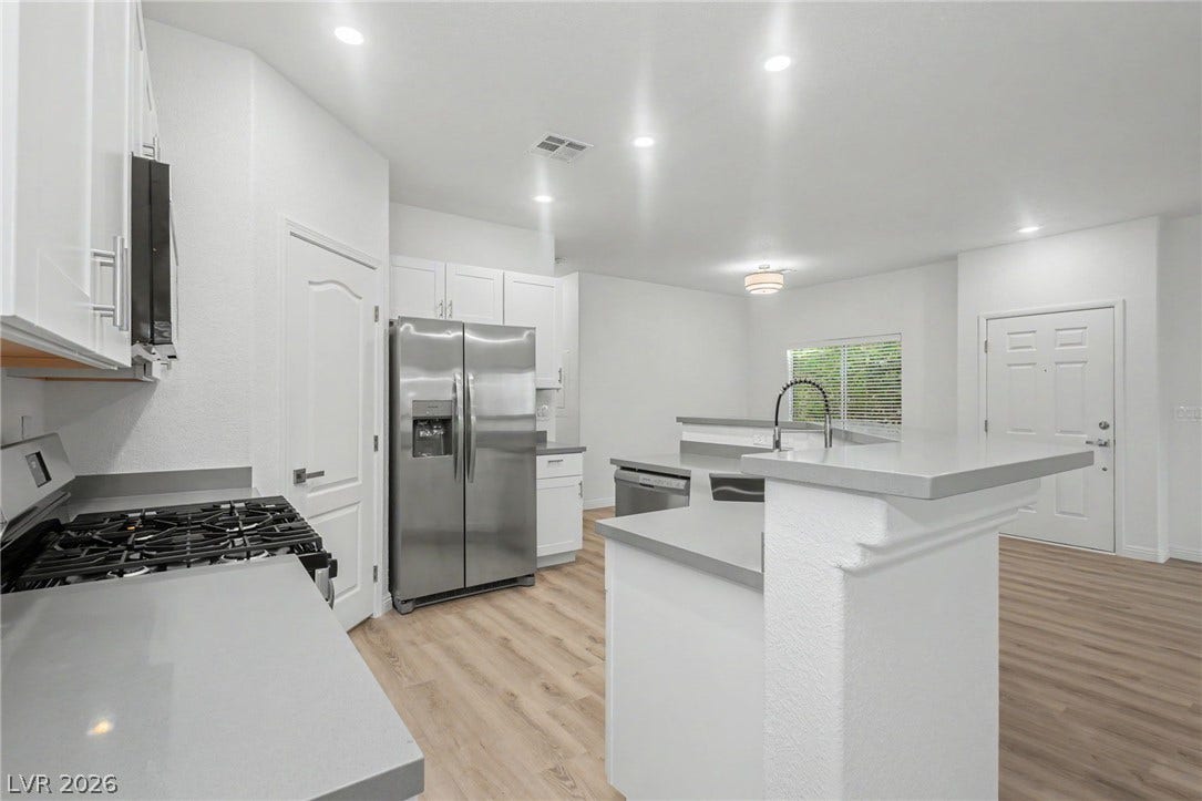 1555 Ward Frontier Lane, Henderson, NV 89002 Recessed lighting illuminates this modern culinary space featuring stainless steel appliances and light wood floors.