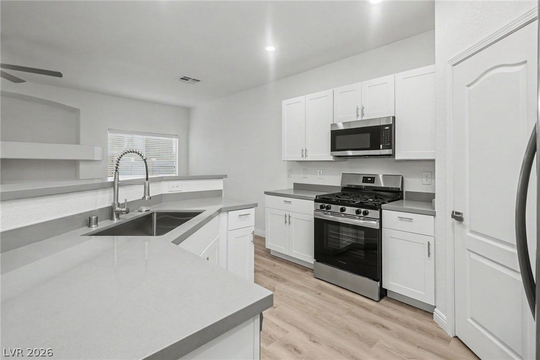 1555 Ward Frontier Lane, Henderson, NV 89002 Modern cabinetry and solid counters pair perfectly with quality appliances in this updated space.