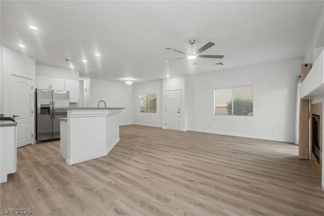 1555 Ward Frontier Lane, Henderson, NV 89002 Gleaming wood-look floors unite this airy open layout connecting kitchen and living spaces.