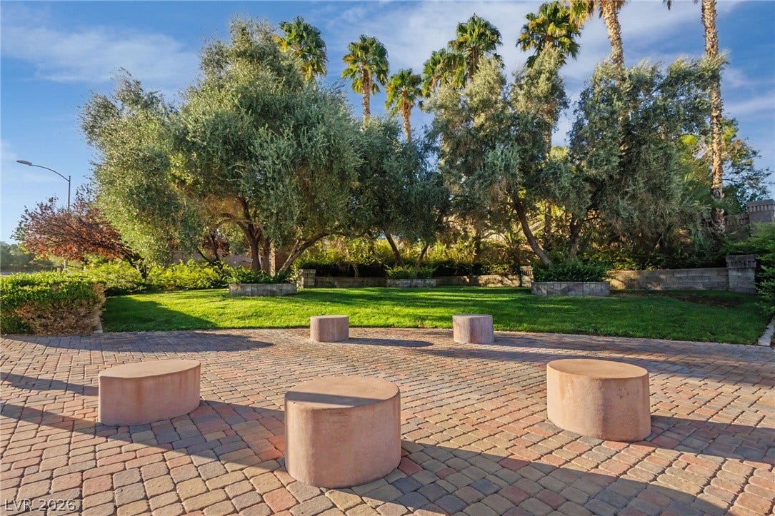 1555 Ward Frontier Lane, Henderson, NV 89002 Mature trees and a manicured lawn border the spacious brick paver patio.