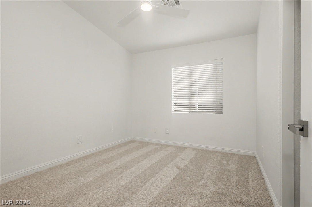 1555 Ward Frontier Lane, Henderson, NV 89002 Soft carpeting pairs with crisp baseboards under a high vaulted ceiling.