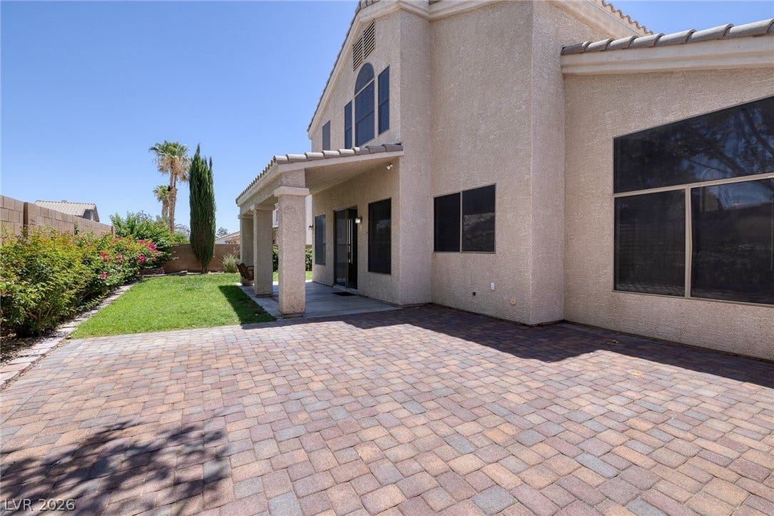 A spacious brick paver patio complements this residence, offering generous outdoor living space.