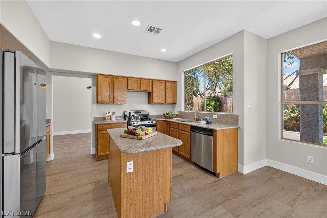 Naturally illuminated plus new recessed lighting, this kitchen features warm cabinetry, ample counter space, and direct access to formal dining room.
