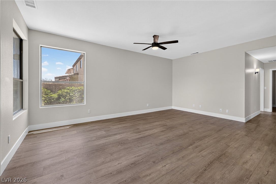 A well-lit, generous interior space boasts resilient LVP flooring and a ceiling fan for year-round comfort.
