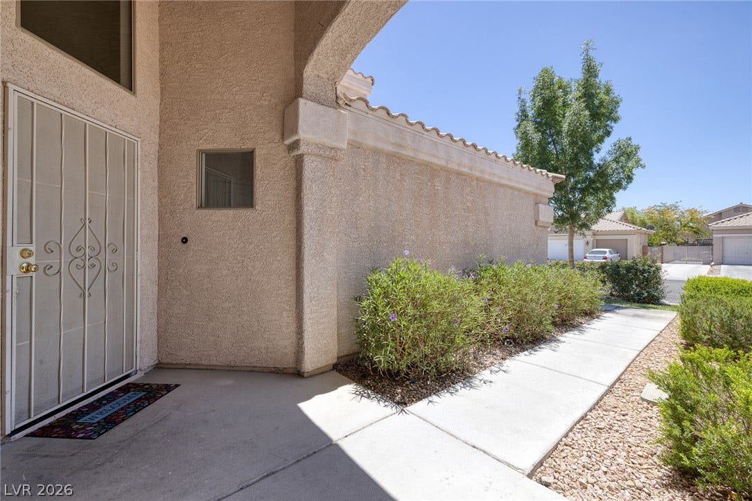 A welcoming entry path leads to this desert-hued residence.