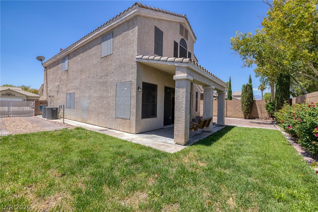 REAL lawn extends from a covered patio space, ideal for outdoor relaxation and your new dog! .