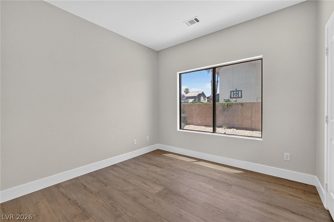 Natural light bathes downstairs Bedroom #4  with eastern exposure and a view to the side yard.