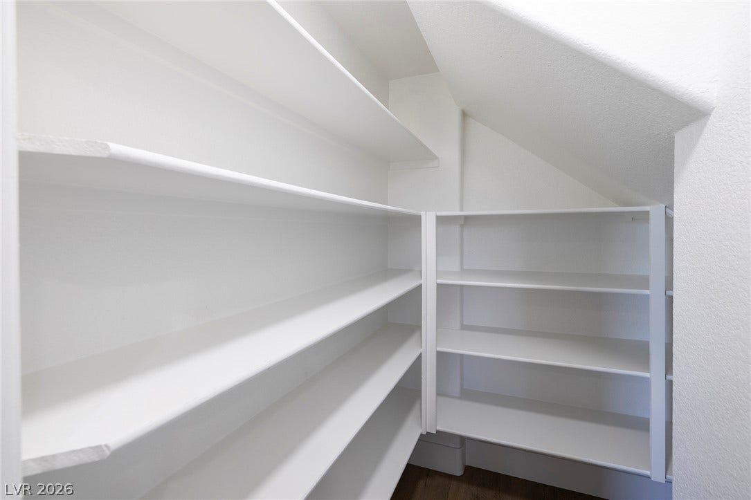 Built-in deep shelving provides generous kitchen storage in this Walk-in Pantry.