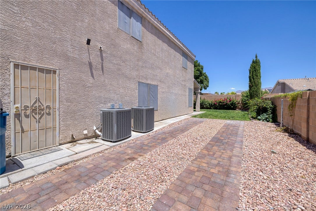 Side yard Gated RV Parking with direct access to garage service door for easy RV load in.