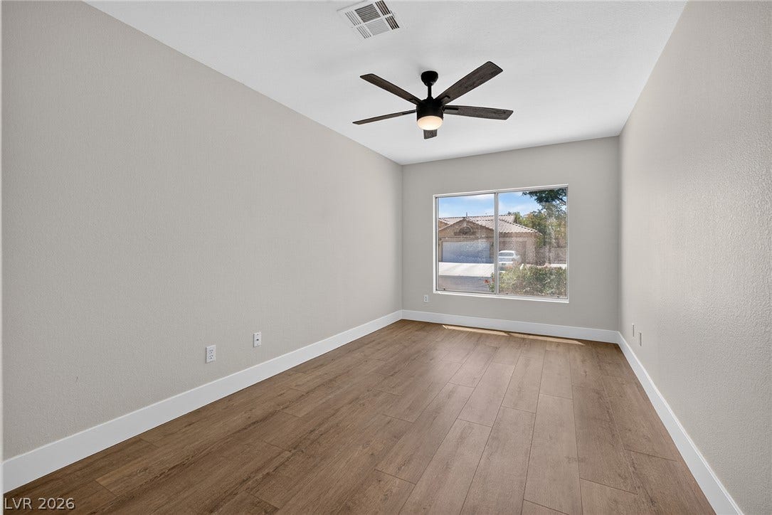 Spacious downstairs Bedroom #5 has a ceiling fan and southern exposure.