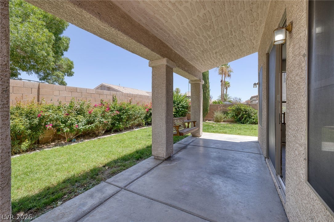 A spacious covered patio provides a shaded oasis for outdoor enjoyment.