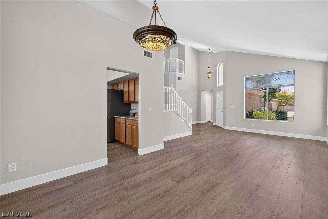 The Dining Room, with direct kitchen access, overlooks the spacious living area with soaring vaulted ceilings.
