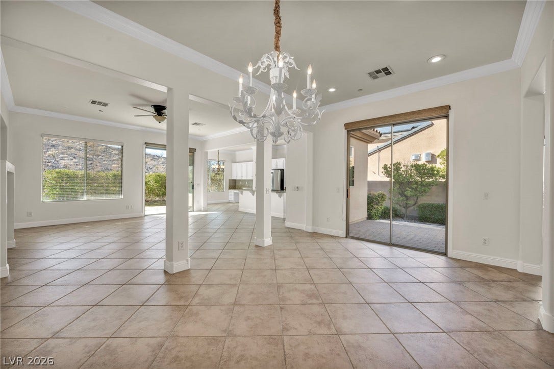 37 Stonemark Drive, Henderson, NV 89052 Unfurnished dining area with visible vents, ceiling fan with notable chandelier, and a healthy amount of sunlight