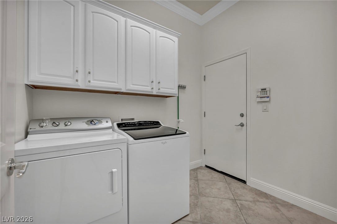37 Stonemark Drive, Henderson, NV 89052 Washroom with light tile patterned floors, baseboards, crown molding, independent washer and dryer, and cabinet space