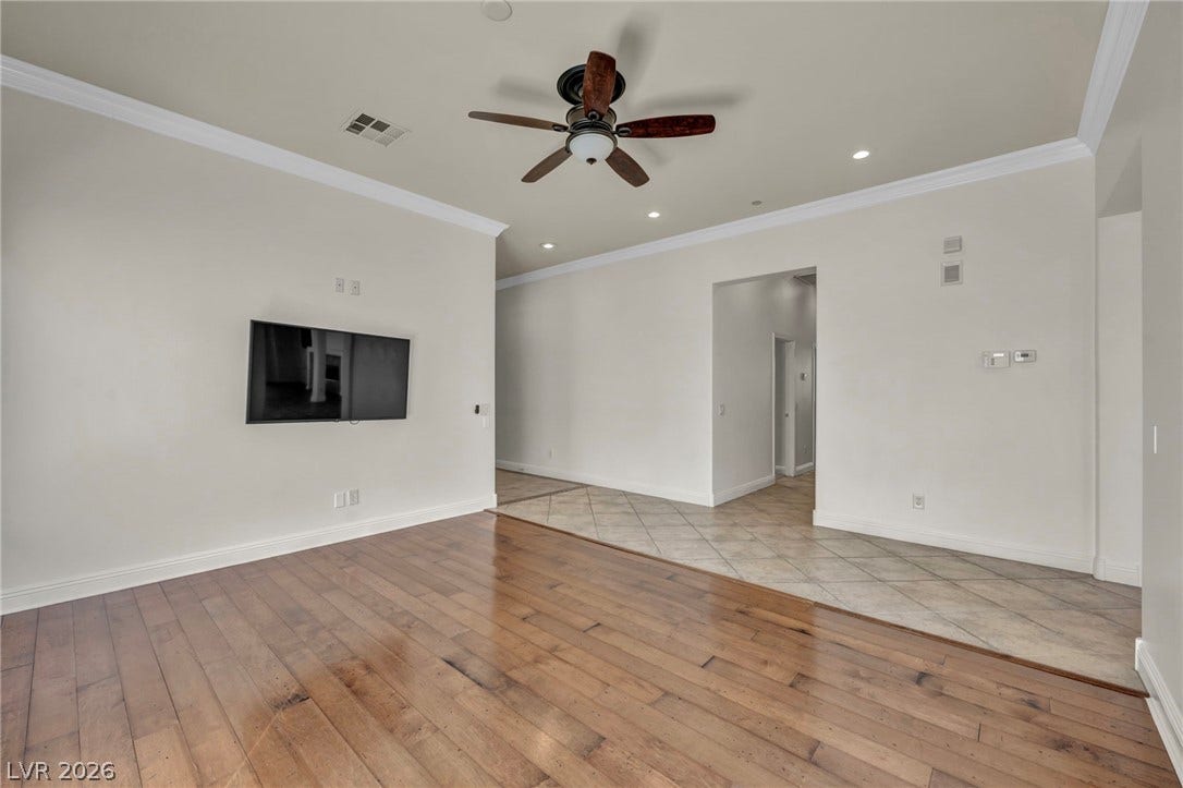 37 Stonemark Drive, Henderson, NV 89052 Unfurnished living room with crown molding, visible vents, light wood-style flooring, and a ceiling fan