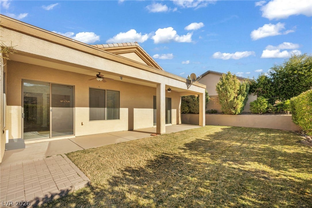 37 Stonemark Drive, Henderson, NV 89052 Back of house with a patio area, ceiling fan, a yard, and stucco siding