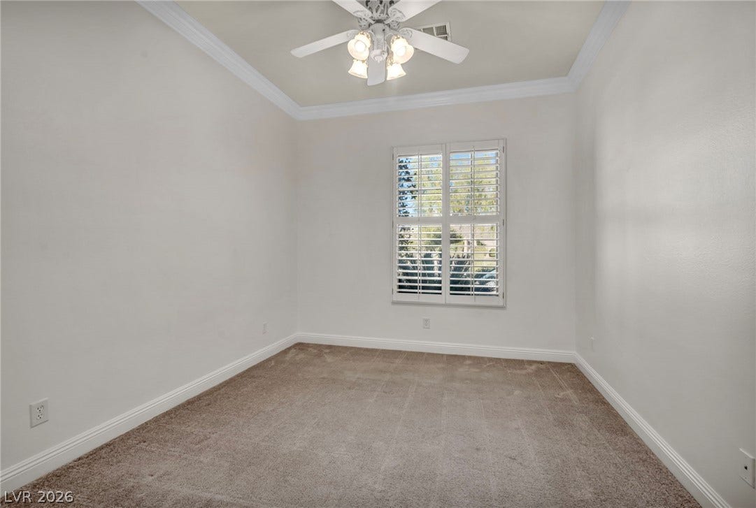 37 Stonemark Drive, Henderson, NV 89052 Carpeted spare room featuring crown molding, ceiling fan, baseboards, and visible vents