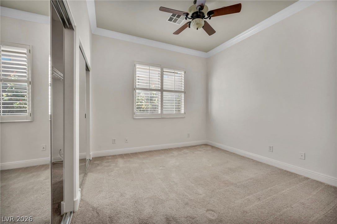 37 Stonemark Drive, Henderson, NV 89052 Unfurnished bedroom with crown molding, baseboards, multiple windows, and carpet flooring