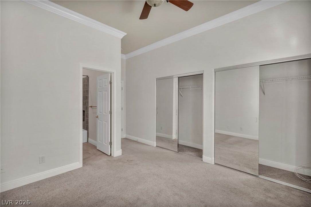 37 Stonemark Drive, Henderson, NV 89052 Unfurnished bedroom featuring crown molding, a ceiling fan, carpet flooring, multiple closets, and baseboards
