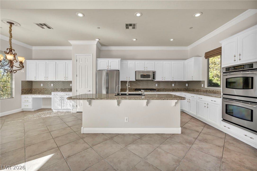 37 Stonemark Drive, Henderson, NV 89052 Kitchen with stone counters, visible vents, light tile patterned flooring, and appliances with stainless steel finishes