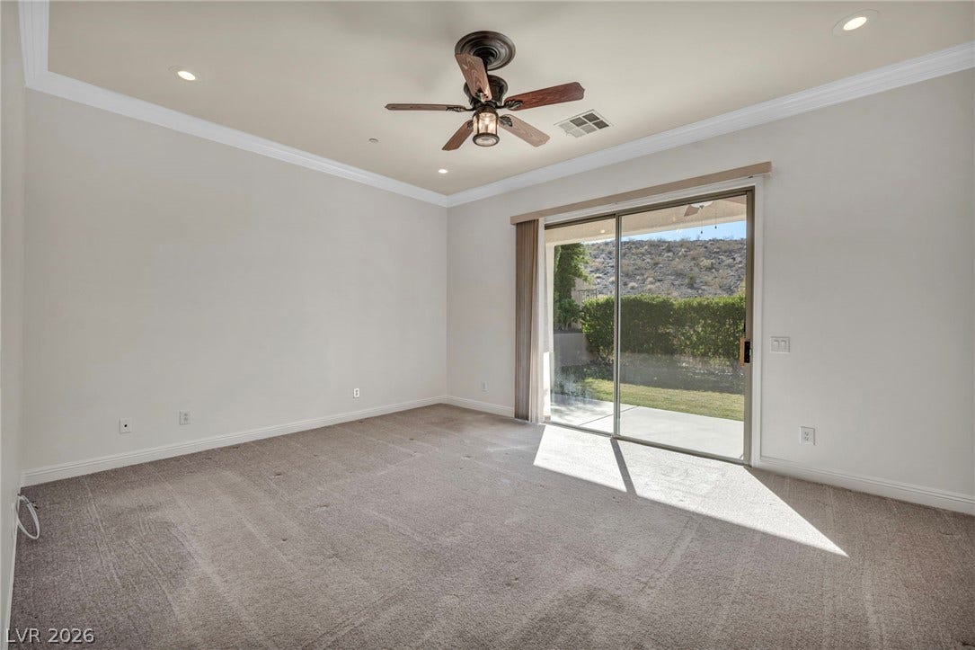 37 Stonemark Drive, Henderson, NV 89052 Empty room with ornamental molding, visible vents, ceiling fan, and carpet floors