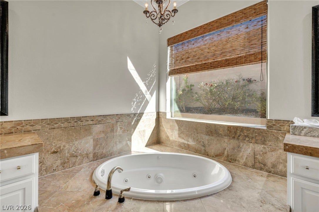 37 Stonemark Drive, Henderson, NV 89052 Full bathroom featuring a jetted tub, vanity, and an inviting chandelier