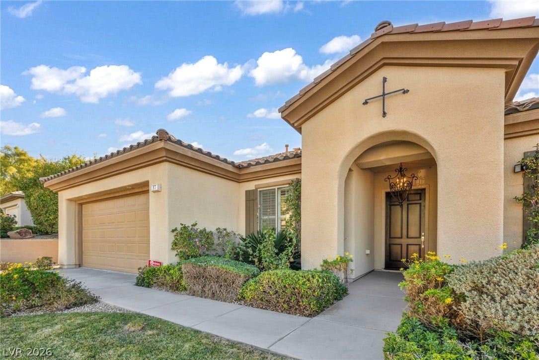 37 Stonemark Drive, Henderson, NV 89052 Entrance to property with a garage, stucco siding, and a tiled roof