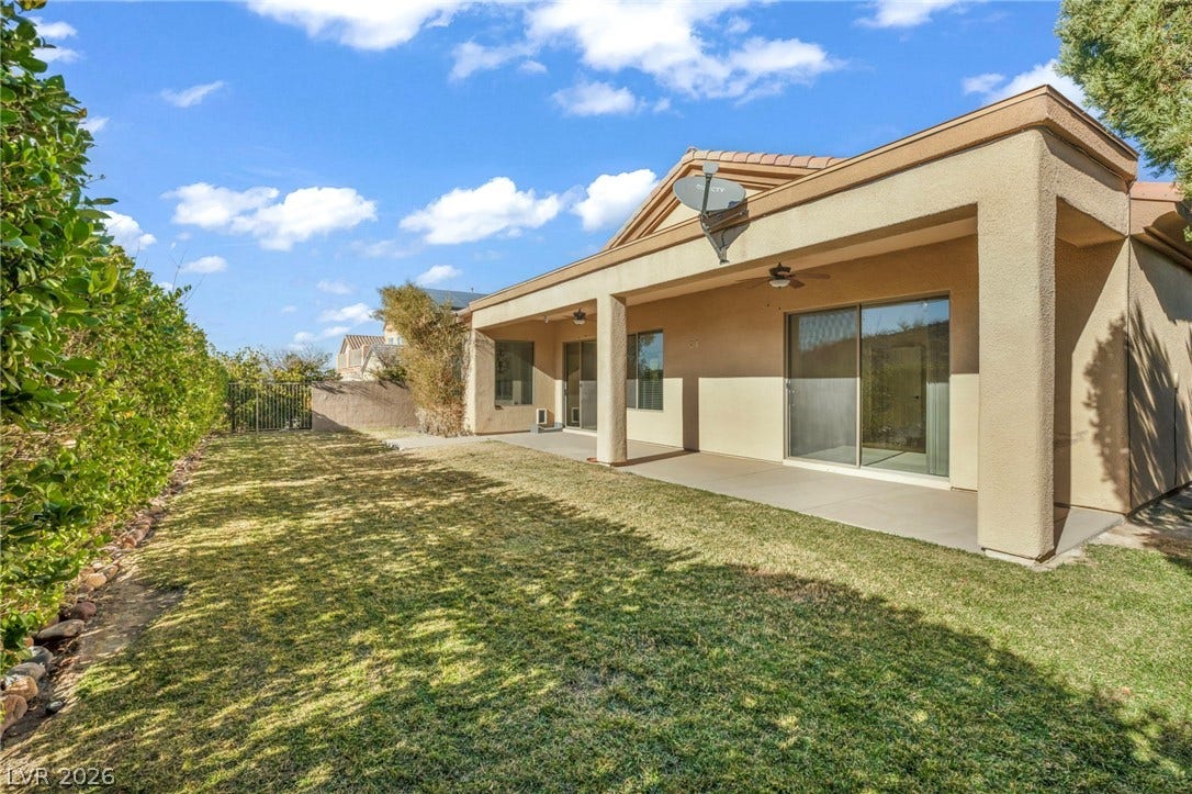 37 Stonemark Drive, Henderson, NV 89052 Rear view of property featuring ceiling fan, a yard, stucco siding, a patio, and fence