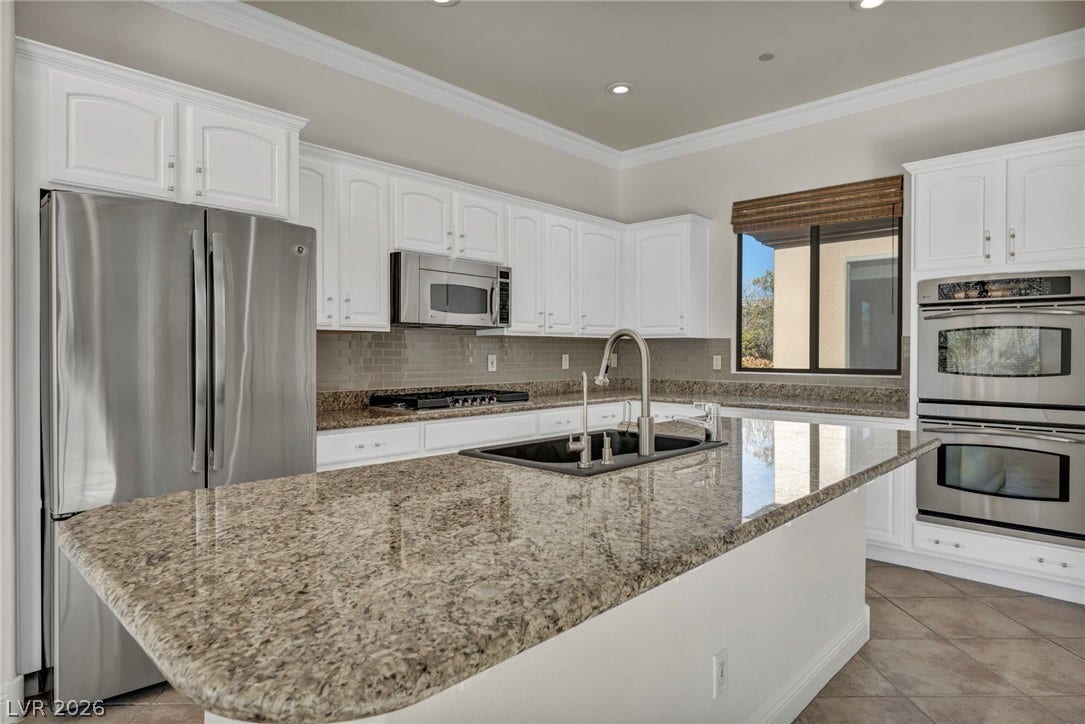 37 Stonemark Drive, Henderson, NV 89052 Kitchen featuring a sink, white cabinetry, and stainless steel appliances