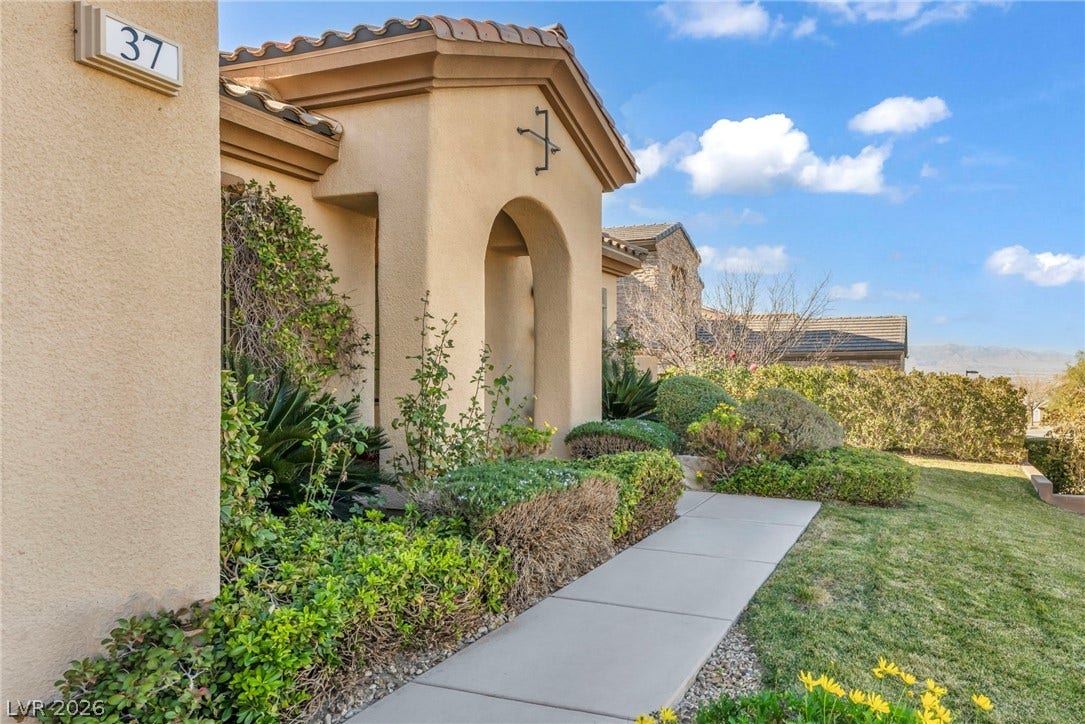 37 Stonemark Drive, Henderson, NV 89052 Entrance to property featuring a yard, stucco siding, and a tiled roof