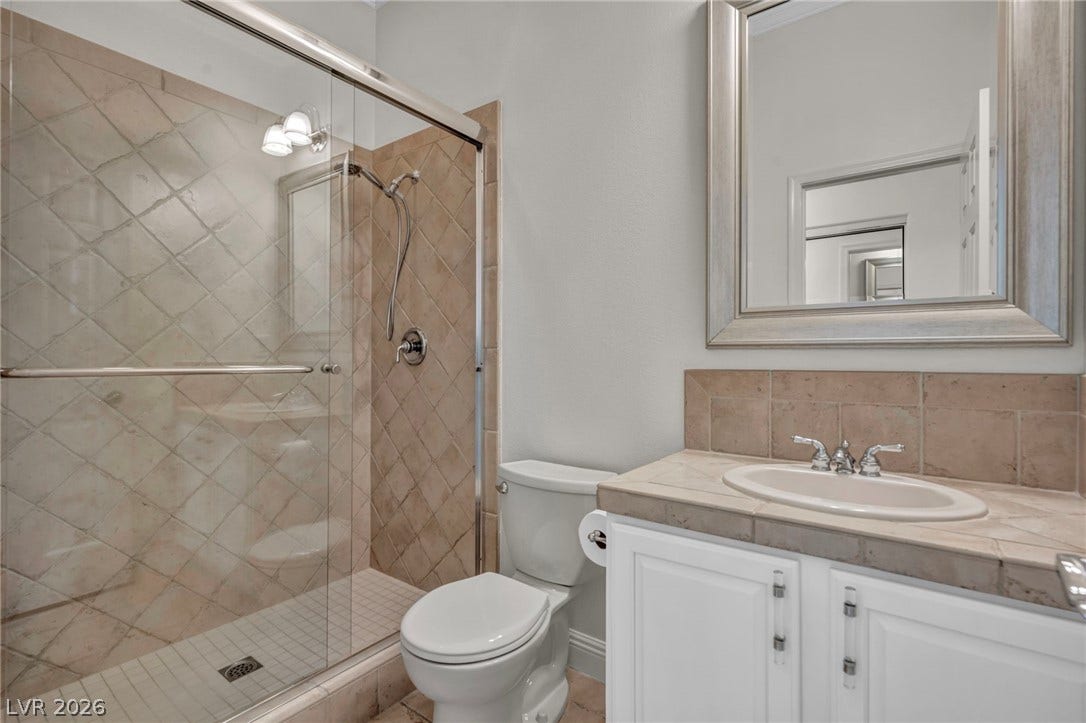 37 Stonemark Drive, Henderson, NV 89052 Bathroom with toilet, a stall shower, and vanity