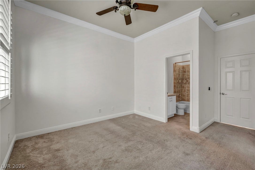 37 Stonemark Drive, Henderson, NV 89052 Unfurnished bedroom featuring crown molding, baseboards, connected bathroom, and light carpet