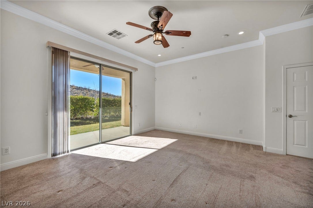 37 Stonemark Drive, Henderson, NV 89052 Spare room featuring visible vents, baseboards, a ceiling fan, crown molding, and carpet flooring