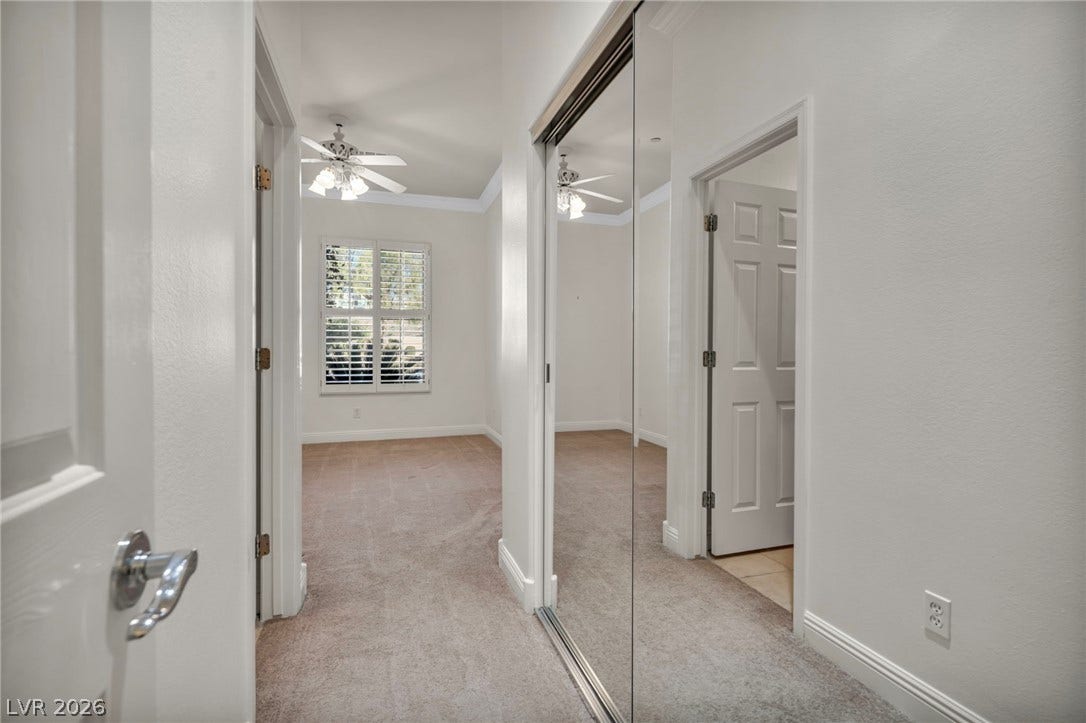 37 Stonemark Drive, Henderson, NV 89052 Hallway featuring baseboards, light colored carpet, and crown molding