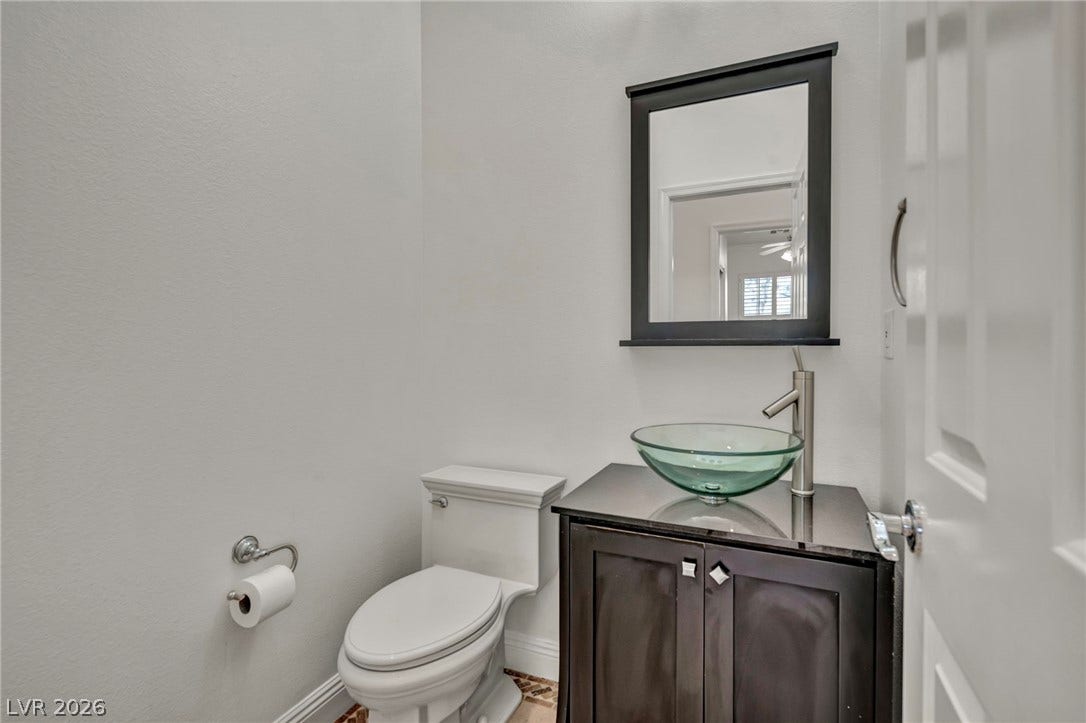 37 Stonemark Drive, Henderson, NV 89052 Half bath with toilet, vanity, and baseboards