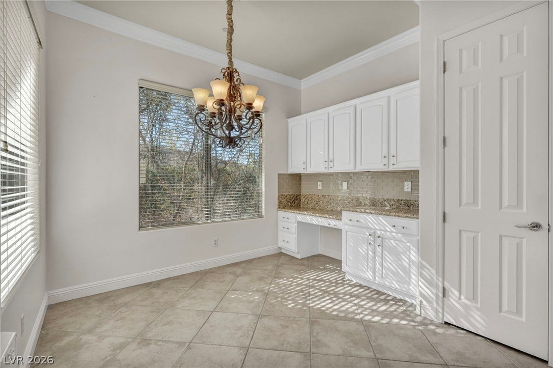 37 Stonemark Drive, Henderson, NV 89052 Unfurnished dining area with a chandelier, ornamental molding, baseboards, and light tile patterned flooring