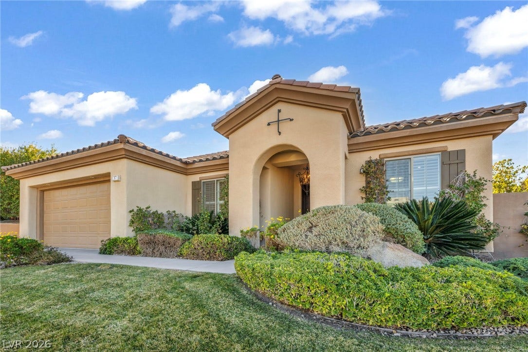 37 Stonemark Drive, Henderson, NV 89052 Mediterranean / spanish home with a front yard, a tile roof, a garage, and stucco siding