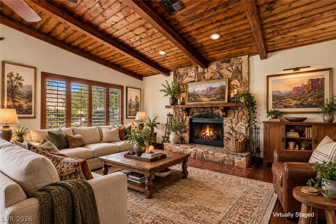 29 Cottonwood Drive, Blue Diamond, NV 89004 Rich wood plank ceilings and a massive stone fireplace anchor this warm living space.