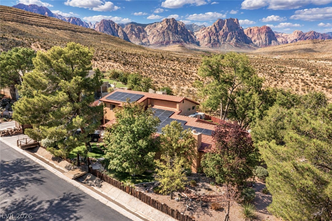 29 Cottonwood Drive, Blue Diamond, NV 89004 Dramatic mountain ranges frame this hillside home equipped with rooftop solar panels.