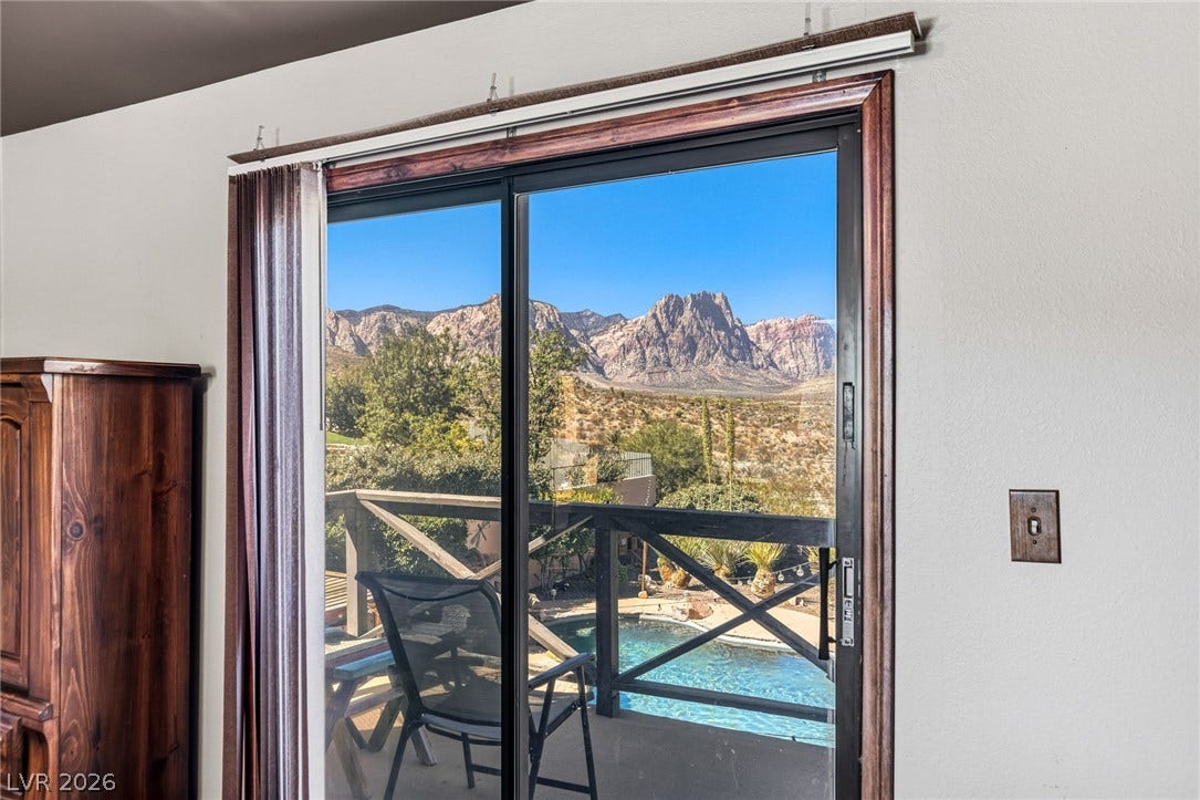 29 Cottonwood Drive, Blue Diamond, NV 89004 Dramatic mountain vistas frame the view through sliding glass doors leading to the balcony.