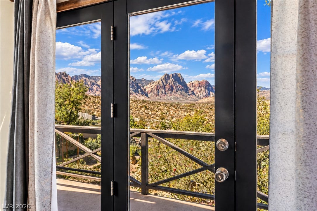 29 Cottonwood Drive, Blue Diamond, NV 89004 Glass doors from the primary suite to the large wrap around balcony with amazing Red Rock views.